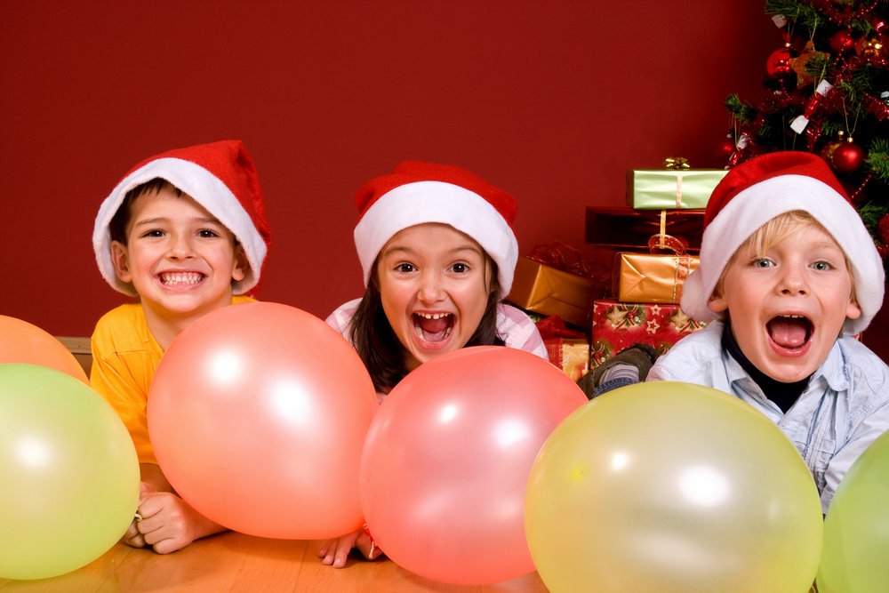Дети с воздушными шарами в новогодних колпаках